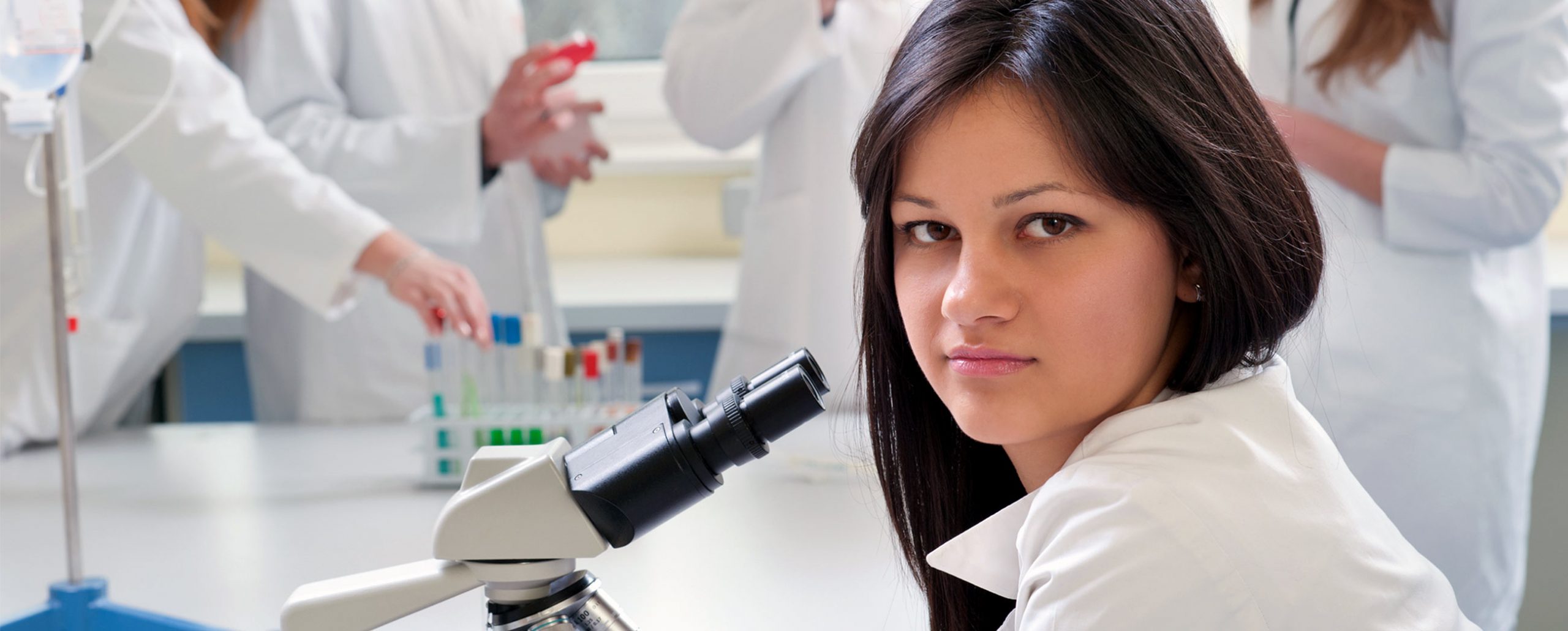 Student looking through microscope