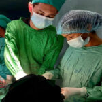 two doctors performing surgery in operating room