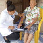 doctor taking blood pressure of patient